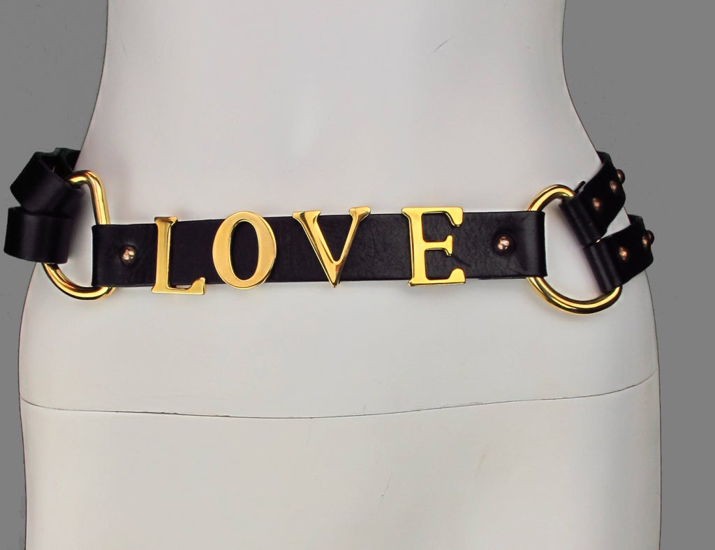 Double wrap studded leather LOVE belt...Individual gold metal letters spell LOVE adjustable straps with button through metal stud...D rings at each side front...Marked 38...

Measurements are: 
38
