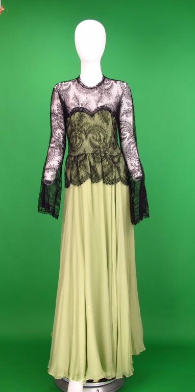 Soft flowing,pale mint green silk chiffon and Chantilly lace gown create a unique and exotic dress...The over bodice of fine black Chantilly lace has long raglan sleeves and graceful draped bell cuffs...The over bodice is fitted and has a peplum