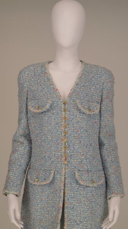 Chanel blue confetti tweed coat with printed silk lining, from the 1990's...Classic Chanel style with V neck button front & 4 button flap pockets, princess seams...Clear logo buttons with gold CC's...All our clothing is dry cleaned and inspected for