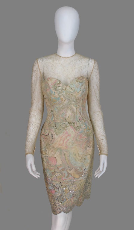 Vera Wang champagne blond & gold lace cocktail dress...Light as air lace is over layed on a silk sheath that has a swirling pattern of pale pinks and blues...The long sleeve fitted dress has built in corset with padding in the bust that could be