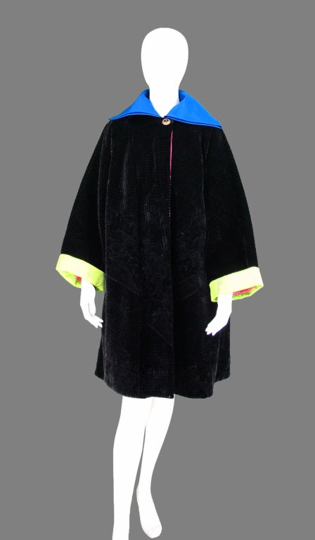 Versace Couture black velvet trapunto style quilted black velvet swing coat...Punches of colour define this 80s coat that will brighten any dull winter day...Black velvet has detailed quilting in a classic floral pattern...Lime green quilted silk