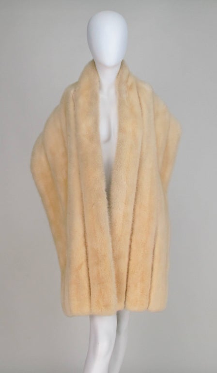 Champagne mink fur stole from the 1960s...Wide bands of mink fur with cream silk faille insertion...The stole is fully lined in cream figured silk, there are bands for your arms, there is some wear to the silk lining along the bottom inside edge,