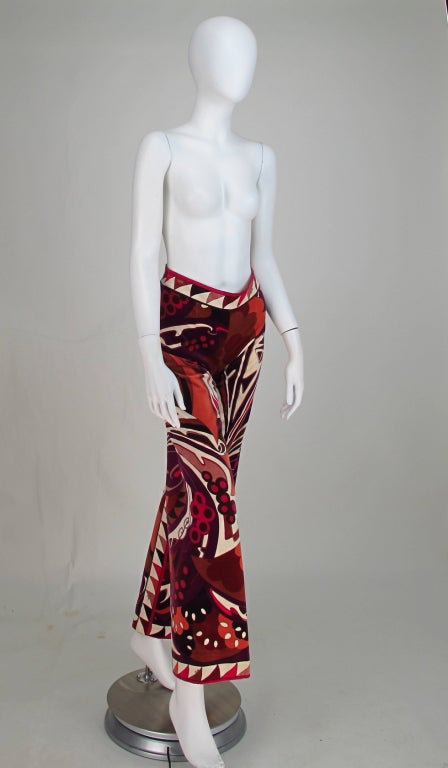 The colours in the print of these Pucci velvet trousers is warm and rich and perfect for winter wear...Cotton velveteen fitted trousers have wide legs and a curved fitted waist, closing at the back with a hook/eye and painted metal zipper...Trousers