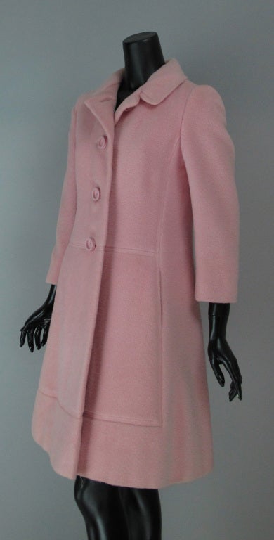 Pale pink wool coat from the 1960s…very Mod in it’s simplicity…wonderful decorative seaming details…on seam front pockets…lined in pink satin.