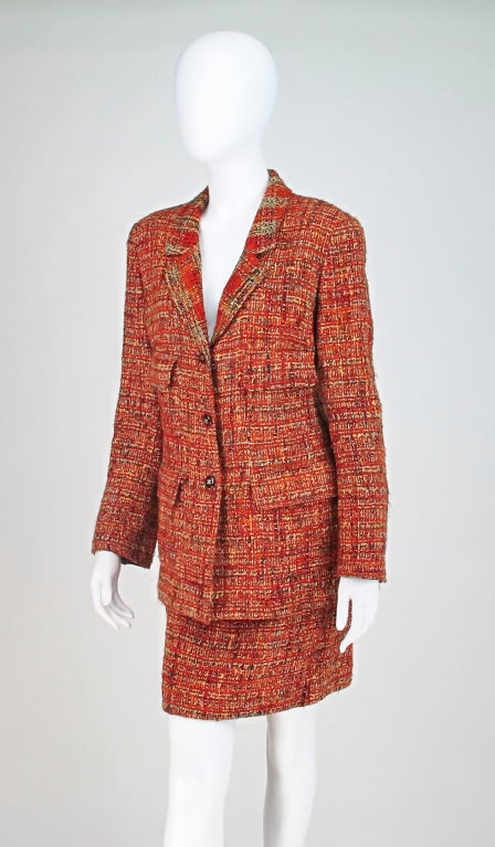 Chanel russet tweed suit...Hip length jacket with three button front closure, four flap pockets, button cuffs, jacket is lined in self fabric...A line skirt with back zipper closure, skirt is fully lined in silk...Marked size 42...

All our