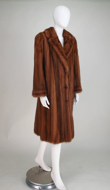 Maggy Rouff mink coat, of full female pelts...Notched lapel, button front, sleeves with banded cuffs, on seam front pockets...Fully lined and in excellent wearable condition, the fur is soft and supple...Measurements are: Bust to 40