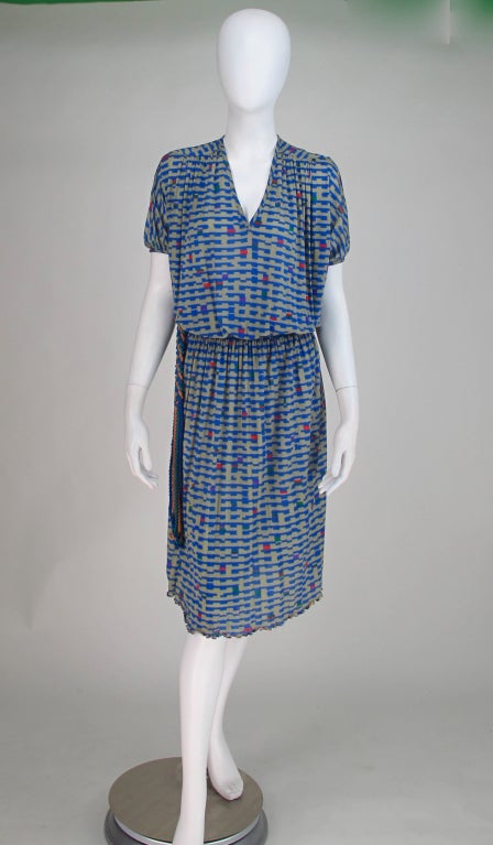 Fine silk knit dress from Missoni, with the original braided belt. Pull on style with V neckline, shaped yoke front and back, short banded sleeves, elastic waist and softly gathered skirt, ruffle edge hem.
 
All our clothing is dry cleaned and