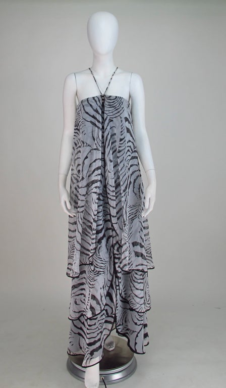 Shear black & white zebra print chiffon tiered gown, from the 1970s. Mr Blackwell loved animal prints and this gown is pretty spectacular. Under dress has a fitted boned bodice,rhinestone detail at center front, narrow straps attach from front