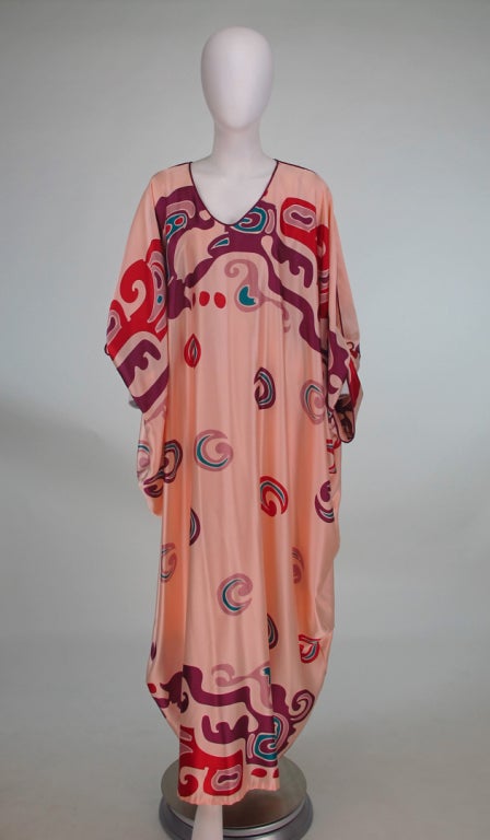 Silky tribal printed caftan from the 1980s from Mary McFadden...Full drape caftan, with deep V neckline, with self ties at wrists, unlined...In excellent wearable condition...One size...

All our clothing is dry cleaned and inspected for condition