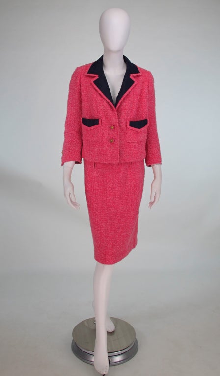 Sadly the label is missing, but the stitching tracks in the upper back lining remain (see detail photo) the shape is undeniably that of the Chanel couture label and the style of the suit definitely 1960s...Lovely pink wool boucle suit with all the