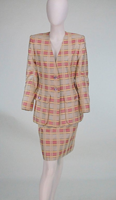 Textured ribbon weave silk in pale ice cream colours...Suit from James Galanos...Fitted hip length V front single breasted suit with big jewel buttons, hip front flap bellows pockets, matching straight skirt, both pieces are fully lined...

All