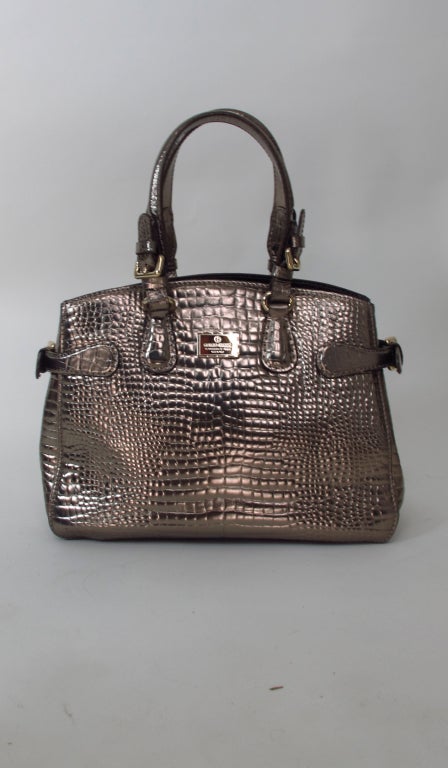 Large silvered bronze leather alligator embossed tote/handbag, iwth matching hardware...Inside center zipper compartment, 2 size zipper compartment (each side)...With protector bag...In barely used condition...

Measurements are: 
13