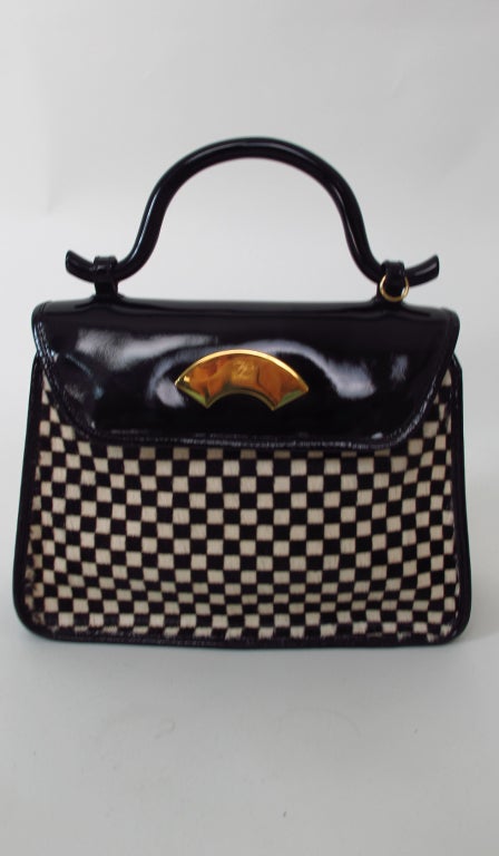Karl Lagerfeld black patent leather, black & white check stenciled hair calf handbag...Structured handle, flap with brass fan closure, black & white stenciled hair calf front & back, trimmed with black patent leather, with black patent leather