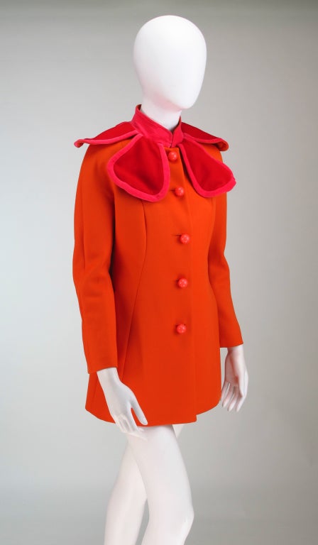 Tangerine wool twill princess seamed jacket from Moschino with hot pink velvet outlining red wool wired petal collar that makes your lovely face the center of the flower...Banded pink velvet stand up collar...Raglan sleeve, single breasted jacket