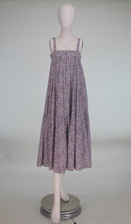 Cacharel floral sun dress in a Liberty of London cotton print...From the 1970s...Pull on style dress with banded bodice, narrow shoulder straps, tiered gathered skirt, with matching wide self belt...In excellent wearable condition...All our clothing