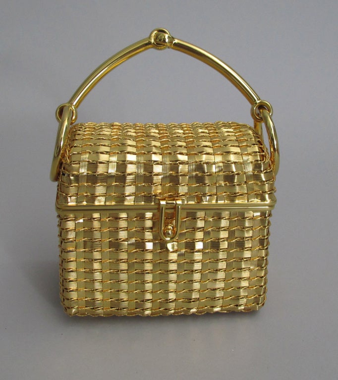 Rodo woven gold box evening bag from the 1960s...form and structure and a bit of whimsy in the horse bit handle...lined in gold...from Saks 5th Ave...with original Rodo protector bag...

Measurements are:
Height 4 1/2