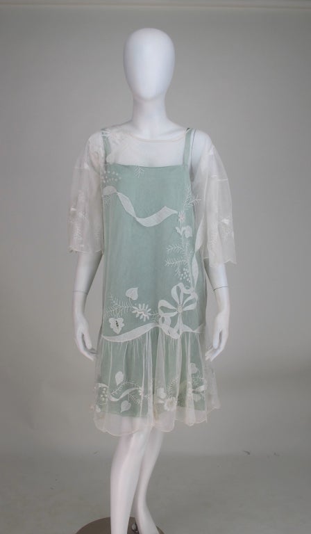 Light as air, ivory embroidered tulle tea dress from the 1920s...Fluttery butterfly sleeves...The fabric is embroidered with ribbons and flowers and has scallop hems...Would make an amazing wedding dress...Pull on style dress with mint green silk