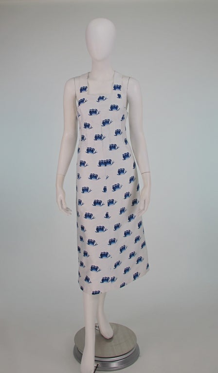 Whimsical print in blue & white,(with a background of diagonal light blue lines) possibly a butterfly in flight or a French favourite escargot...we leave it to personal  interpretation...A summer sun dress from the 1970s by  Courreges...Halter neck