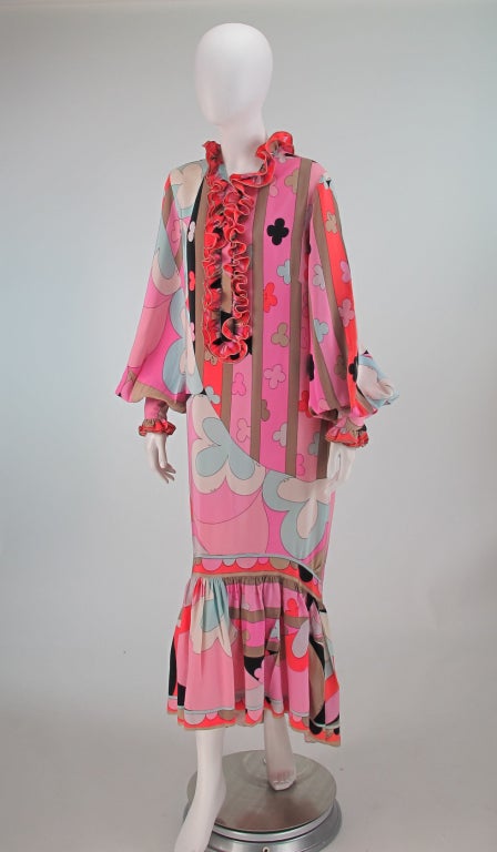 Pucci bold print silk crepe hostess gown from the 1960s...Pull on style dip hem gown with ruffle neckline and front placket, hidden snap closure...Long very full sleeves are gathered into deep cuffs that close with hidden snaps and ruffle edge...The