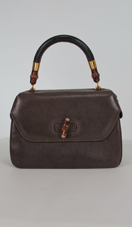Gucci rare fitted dome cover, demi bamboo handle day bag...Large size...Chocolate brown textured leather bag, with top stitch detail and leather lacing at top sides...Gold hardware...Bamboo & leather handle...Single zipper compartment inside, 1 long
