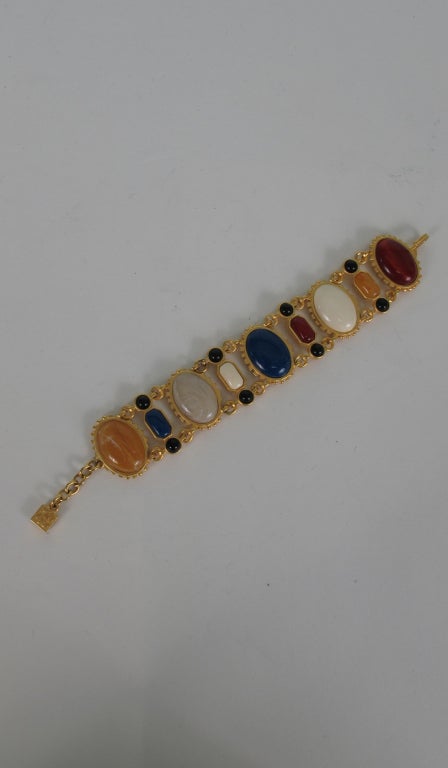 Karl Lagerfeld bracelet with large coloured stone cabochons set in gold...In excellent vintage condition...
Measurements are:
Length of bracelet hook to end of stones 7 1/2