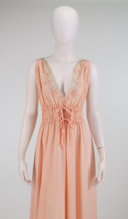 Hand made in France for a bride in Havana, Cuba and part of a wedding trousseau from the 1940s...Crepe de chine gown in peach is hand embroidered and appliqued with flowers & ribbons centered with drawnwork...The décolletage has inset panels of hand