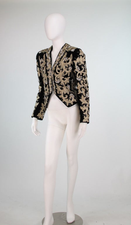 A beautiful evening jacket from Adolfo...Black velvet is covered in gold bullion, gold glass beads, rhinestones & pearls...Open front jacket with cut away front hem that dips a bit in back, fully lined in black...In excellent wearable