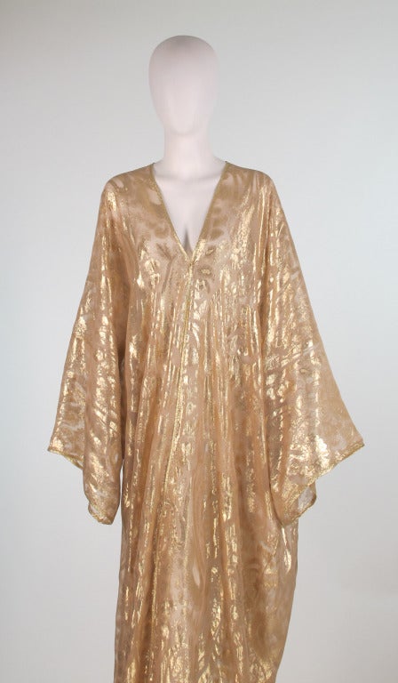 For those who have an imaginative spirit this will give you reason to pause...For at home entertaining this robe is just the thing to make an entrance in...Gold silk tissue brocade kimono style evening robe, with open front and wide kimono