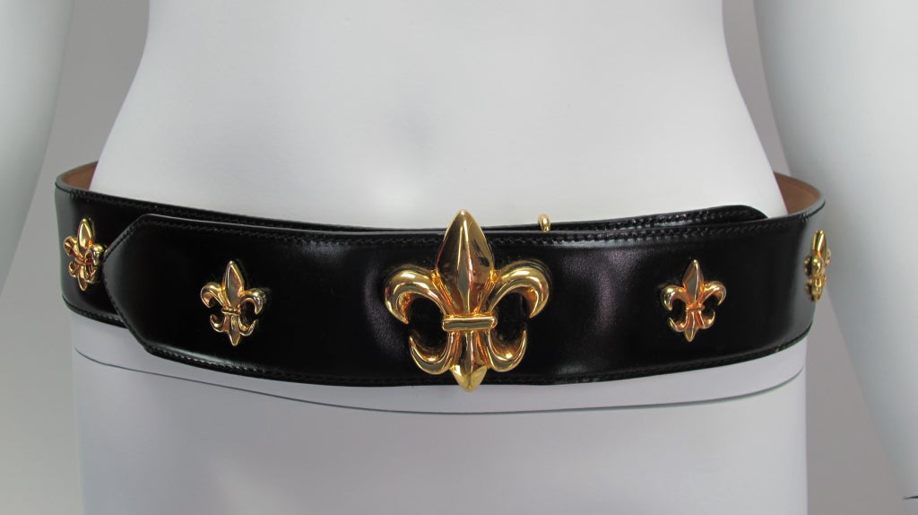 Unique and hard to find,a Moschino belt decorated with gold fleur de lis, give this shiny black leather belt a very French feel…marked Red Wall size 44.