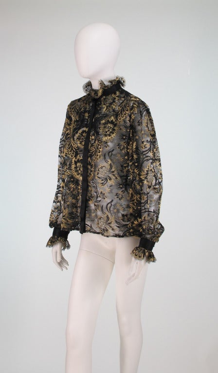 Gorgeous Ungaro sheer black and gold lace blouse from the 1980s...Ruffle neck and cuffs are trimmed in black satin ribbon...Black satin ribbon front, closes with hidden snaps...Cuffs have ball buttons to close...Unlined...Marked size 40...In