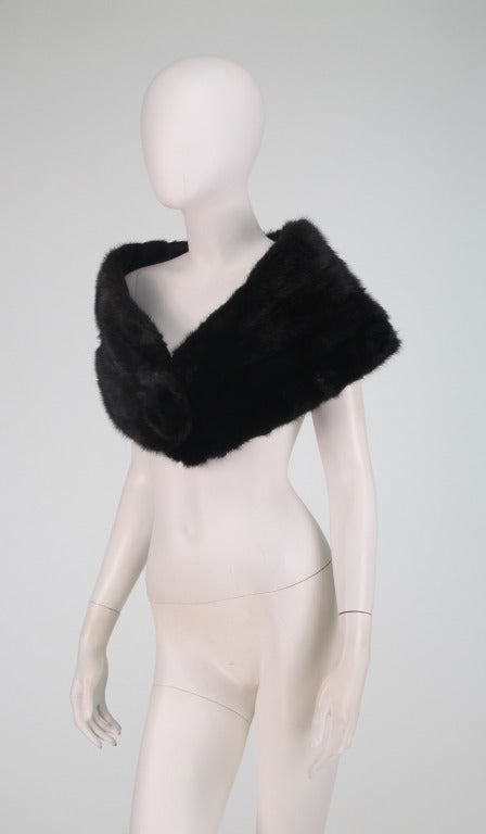 Dark, almost black,  mink fur cape or stole from the 1950s...Closes with a single large mink button...Fully lined and in excellent supple condition. 

Measurements are:
End to end 47