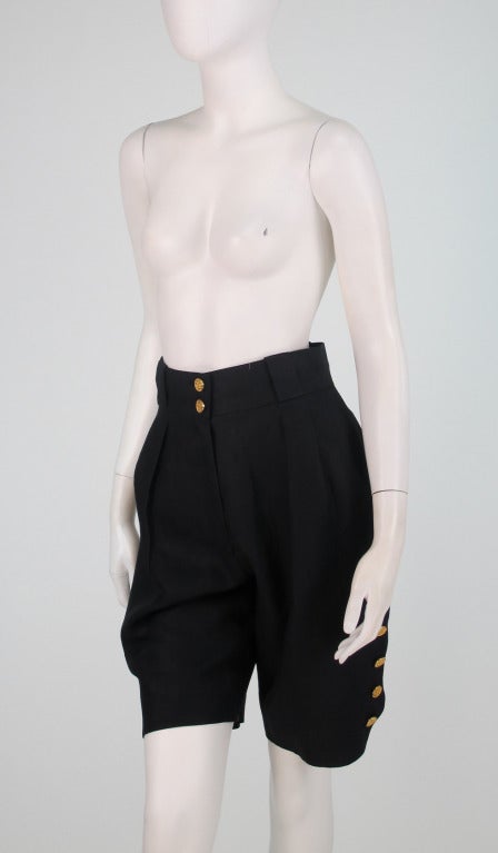Chanel black linen Bermuda length shorts with working side logo button closure...Classic with a twist...Zipper fly front closure...Front pleats...Side pockets...Back pockets (still stitched closed) with logo buttons...Waist band with belt loops
