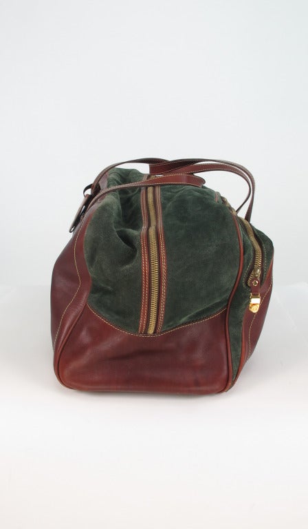 Luxurious, Loewe, Madrid leather & suede duffel bag...Rich dark chocolate brown leather with panels of forest green suede...Embossed logo at center front...Original luggage tag...Double handles...Logo gold feet on the bottom...Front long zipper