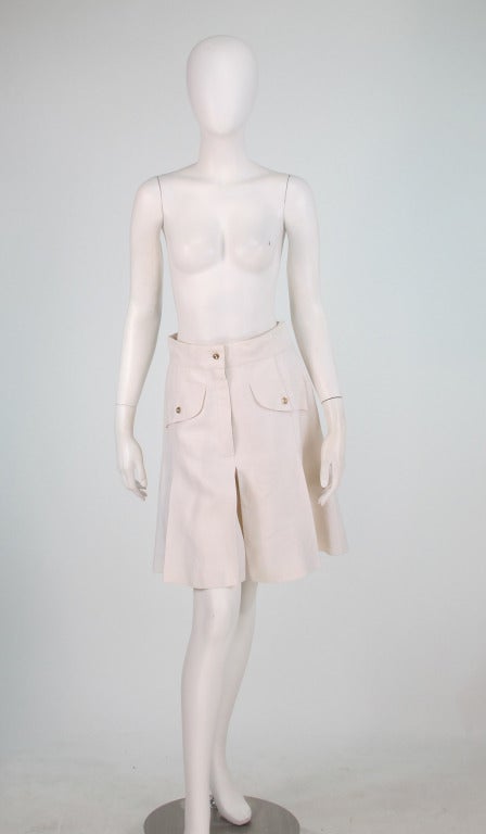 Chanel white linen culotte...Classic style with fly front, banded waist that sits at natural waist, closes with bar hooks...Decorative flaps with log buttons at hip fronts...Stitch down inverted pleats at side fronts...Fully lined in white