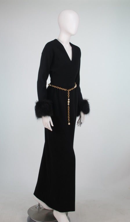 Chic black knit maxi dress from the 1970s...V front neckline with raglan sleeves, fox cuffs & gold & pearl chain belt...Fitted waist...The skirt is slightly gathered at the waist front & has on seam side pockets, straight maxi skirt has a deep hem
