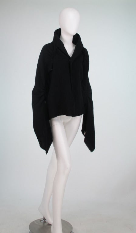 Comme des Garcons...black woven wool jacket, with raglan style sleeve, stand up collar, very long sleeves...Unlined jacket with single hook closure at the front, unfinished seams & edges...Fits like a modern 4...In excellent