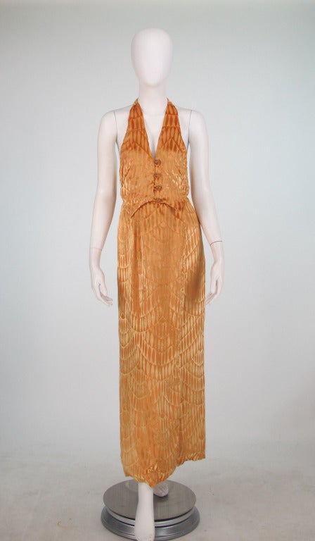 Silk cut velvet jacket in golden orange, trimmed in ostrich feathers with matching halter neck gown...Maxi length dress has a halter neck, with a draped low back, the front of the gown is like a fitted vest with rhinestone buttons at the front, the