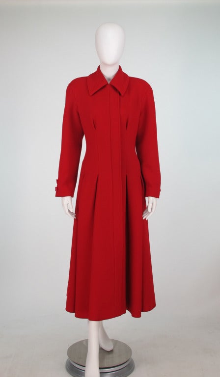 Valentino boutique, fabulous red wool crepe princess waist coat...Seamed inverted pleats at the waist give this coat an amazing shape...Softly padded dropped shoulder...Skirt of coat has a soft fullness...High corollary with stitch detail