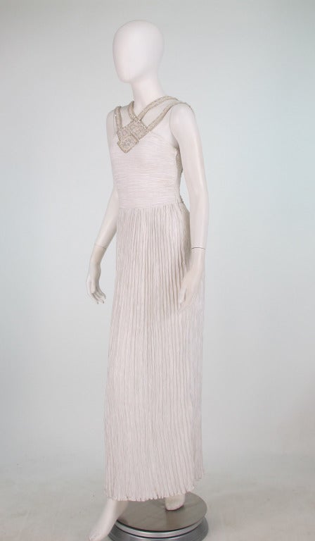 Mary McFadden Couture 1980s white Fortuny styled pleated gown with jeweled cage neck/back...Beautiful silver & white combination for holiday or summer...Heavily beaded bodice, straps and back in silver & crystal...Deep open back, bodice is lined,