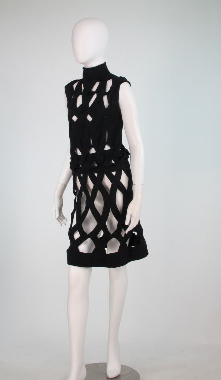 Giorgio Armani, black knitted cage top & skirt...Mock neck top, has banded waist, open knit with diamond shapes...Skirt has a cased elastic waist, banded hem, wide diamond shape openings...Knitted in what feels like fine soft wool...Unlined...very