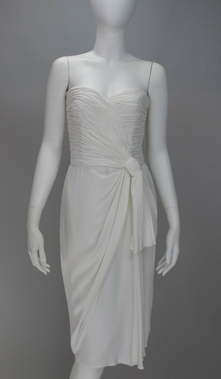 With a nod to the 40s...modern sarong dressing...pleated strapless bodice...glamorous waist wrap and draped skirt...back zipper closure...perfect for summer evening events.