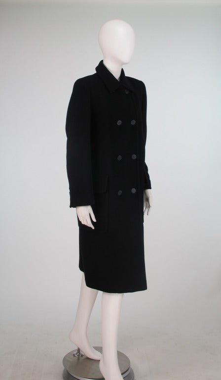 1990s classic style Hermes black cashmere polo coat...Double breasted coat with large flap patch pockets...Gorgeous soft black 100% cashmere...Hermes logo buttons...Hermes logo fabric lining...Marked size 42...This is a coat that will never go out
