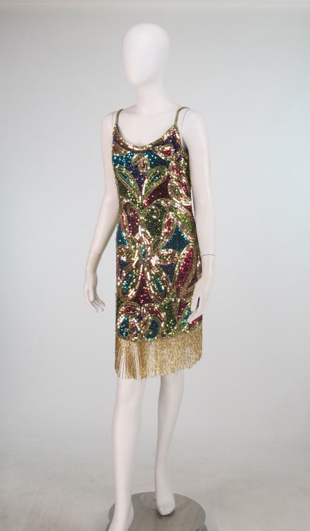 Sequin encrusted beaded fringe cocktail dress from Lillie Rubin 1980s...Low open neckline and deep open back...beaded shoulder straps...Dress is slightly fitted, fully lined and trimmed at the hem in gold glass beaded fringe...Dress closes at the