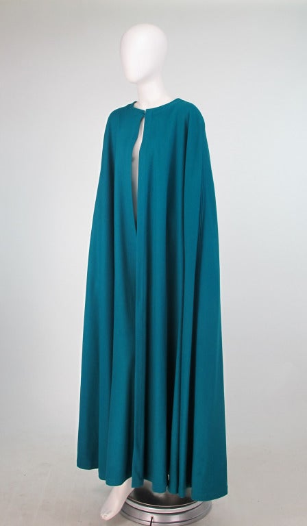 If you need to make a dramatic entrance or exit, do it in this flowing wool cloak from the 1970s from Yves St Laurent...Simple and elegant design in a vivid shade of teal...Unlined wool cape, has single button & loop closure at the neckline, flat