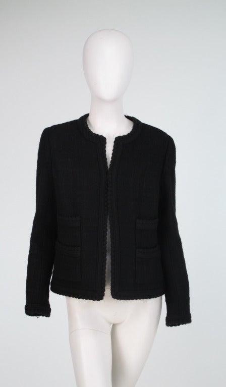 If you are paring your wardrobe down and have room for only one jacket, here is a good choice...A classic 4 pocket boucle jacket in black from Chanel...Boxy style is perfect with jeans, skirts or dresses...Trimmed in braided wool, 4 front pockets,