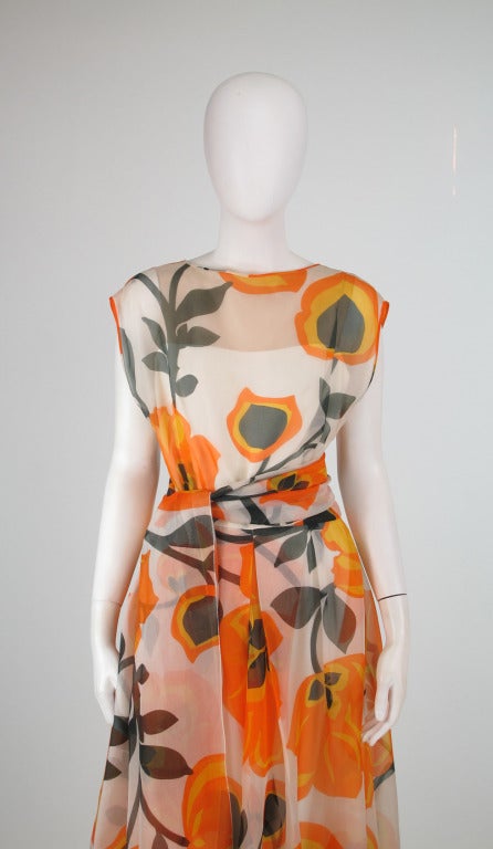 Gorgeous silk organza fantasy floral print gown by Helen Rose from the 1960s...Bateau neckline, shoulder line extends to a cap sleeve...V back neckline...Front pleats at bodice waist...The full skirt has center front and back inverted pleats...The