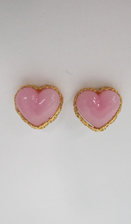 Lovey Chanel poured glass heart earrings marked season 28...rimmed in gold locking C's...Clip back...In excellent wearable condition...

Measurements are:
1