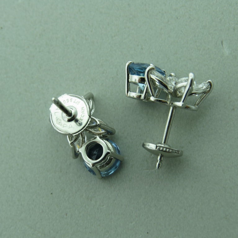 Platinum, diamonds  -1.28Total diamond weight, 2 round aquamarine stones approx. 2.20ctw.  measurements: 14.5mm X 9mm