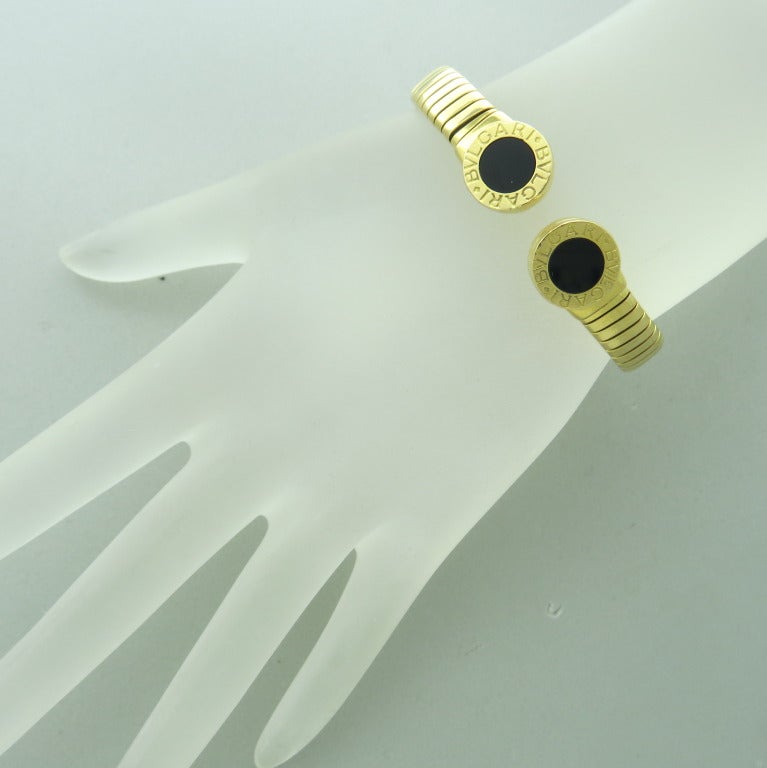 From Bvlgari-Bvlgari Collection, 18k Yellow Gold / onyx,  weight-  33.2g. will fit average size wrist.