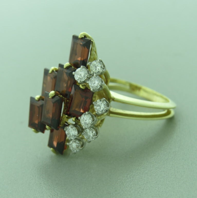 Vintage 1970s Le Triomphe 18k yellow gold ring with garnet and diamonds. Ring size is 6 1/2, ring top is 26m x 19mm. Diamonds are approx. 0.85ctw VS/G. Marked 18kt, Le Triomphe hallmark. weight - 10.8g